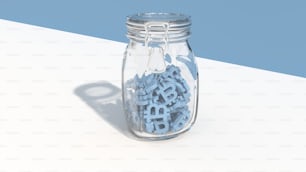 a jar filled with blue letters sitting on top of a table
