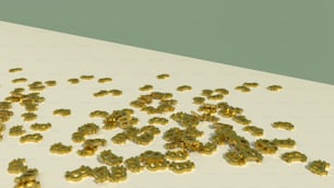une pile de lettres d’or posée sur une table blanche