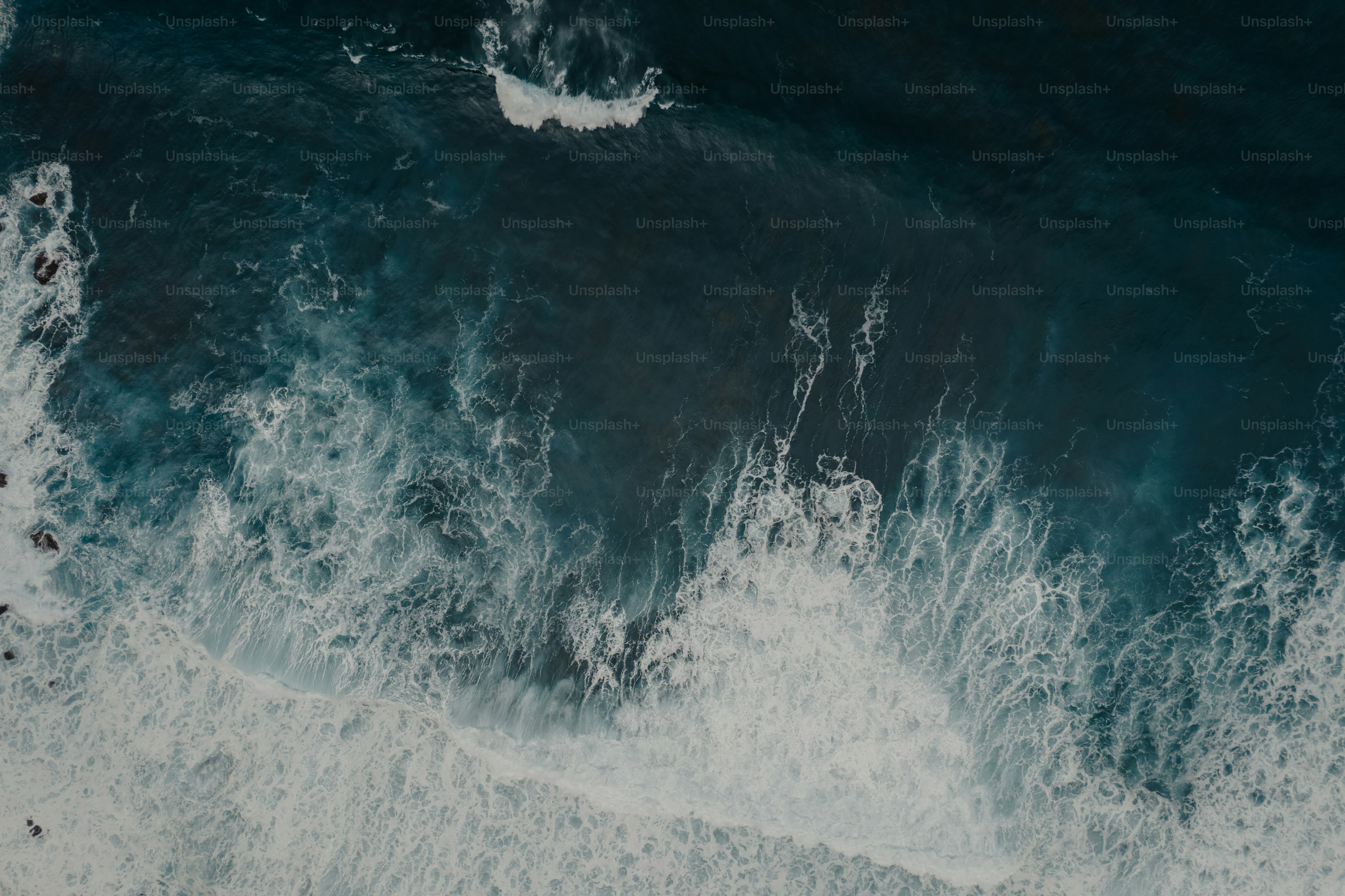 a large body of water with waves crashing on top of it