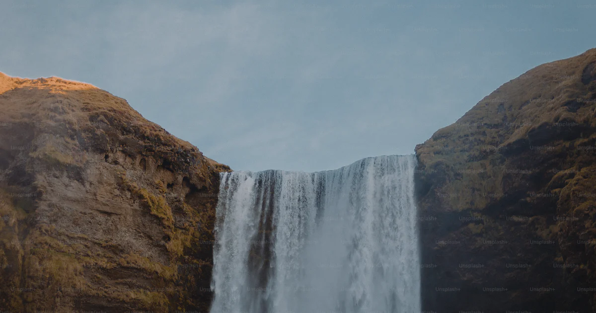 Waterfall Falling Procedure A large waterfall with water falling from it's sides photo – Water ...
