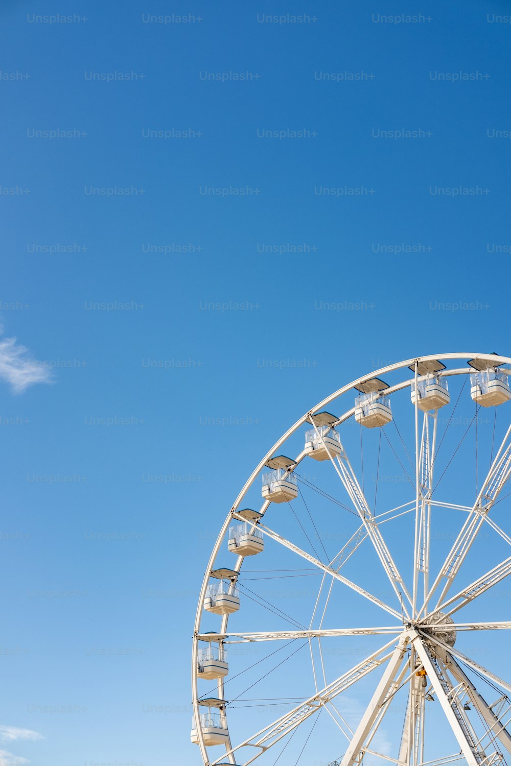 Une grande roue avec un ciel bleu en arrière-plan