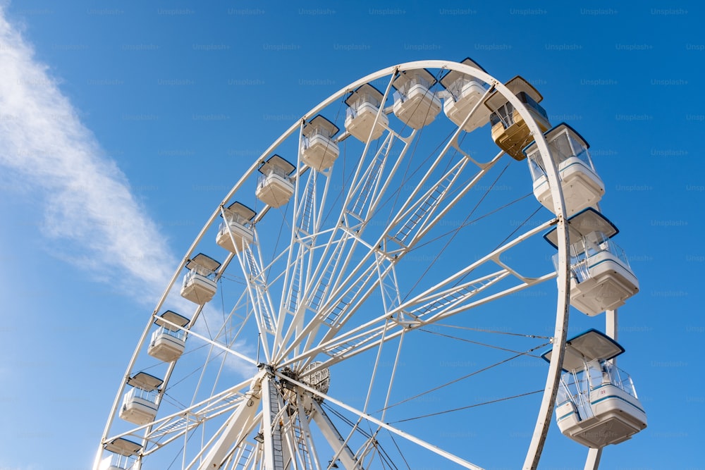 a large ferris wheel sitting under a blue sky