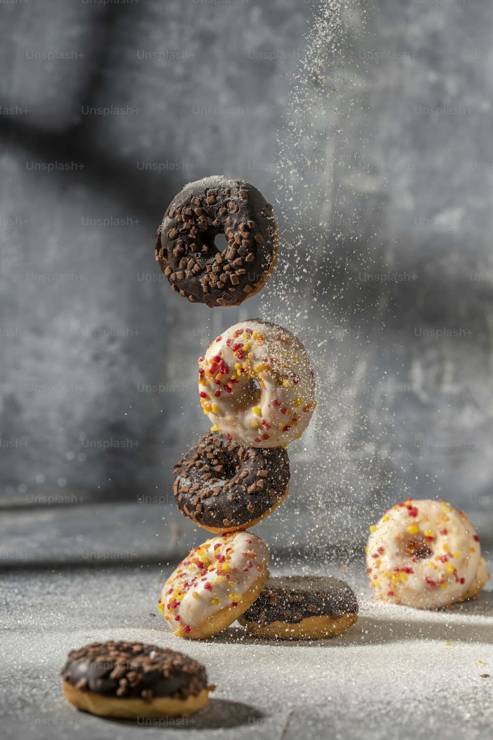 a bunch of doughnuts that are falling into the air