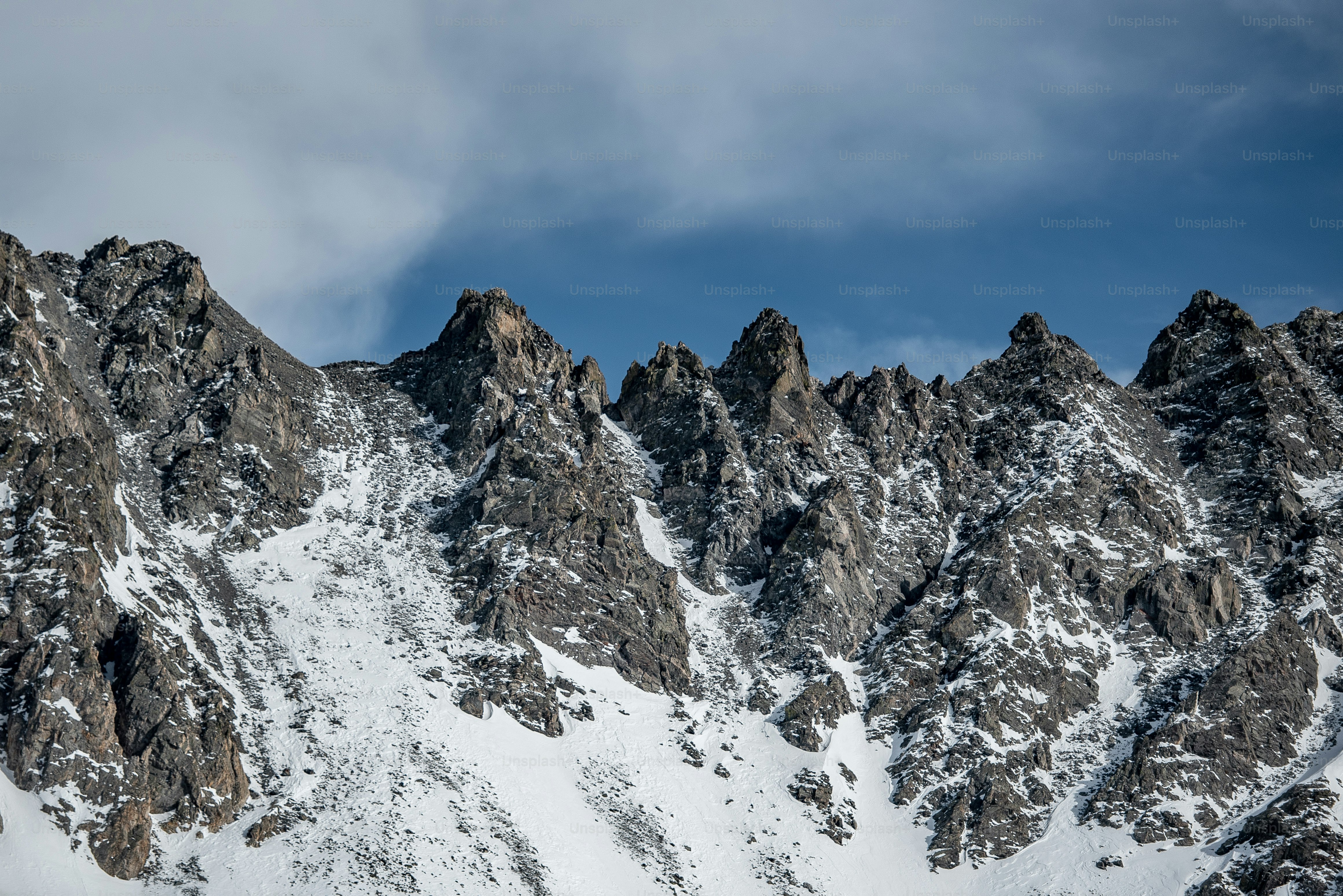 a snow covered mountain with a sky background