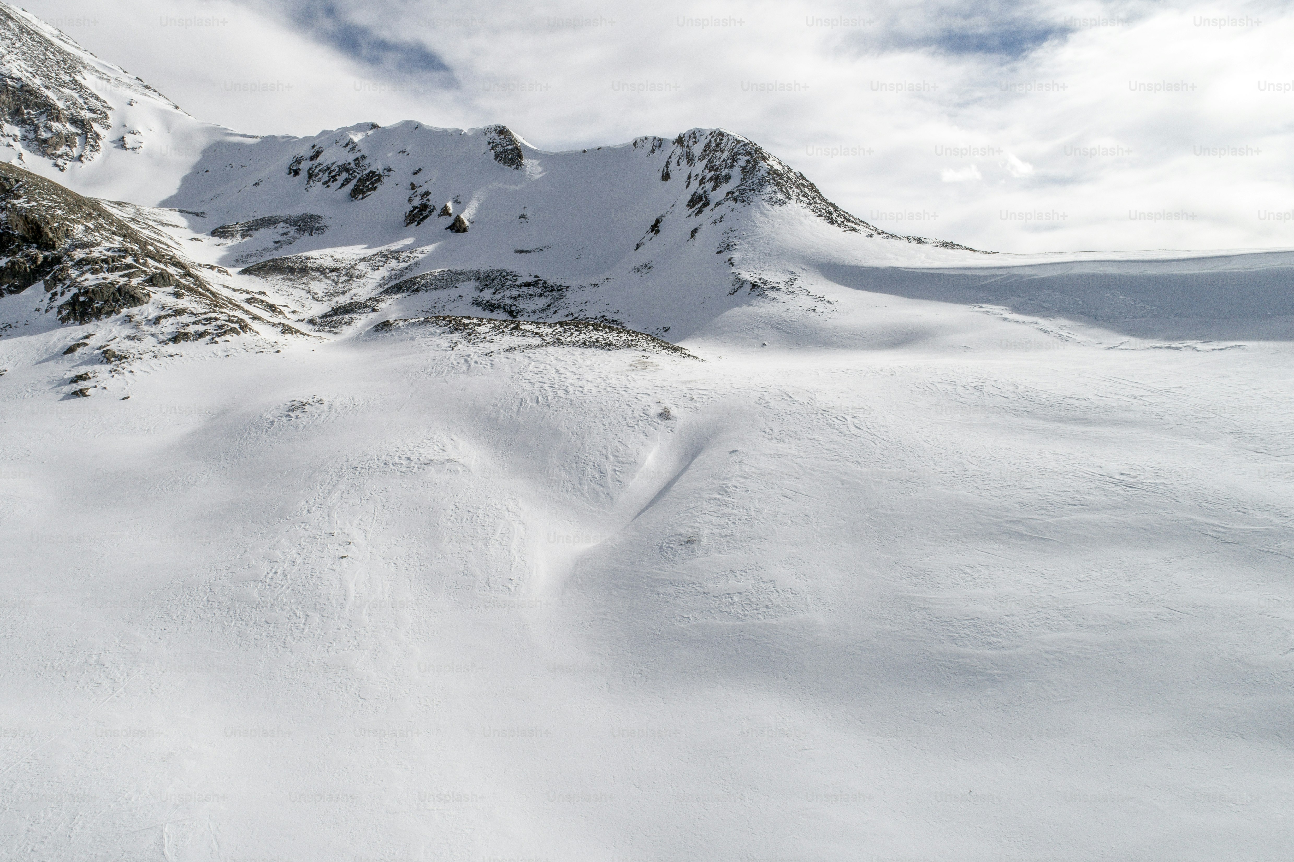 a person riding skis on a snowy surface
