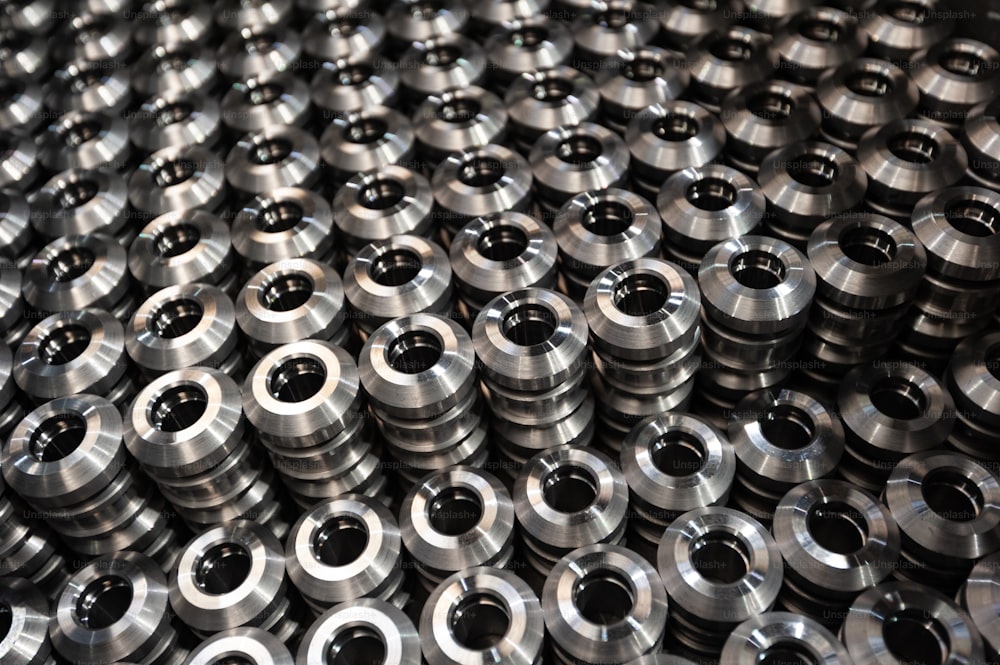 a large amount of metal flanges sitting on top of each other