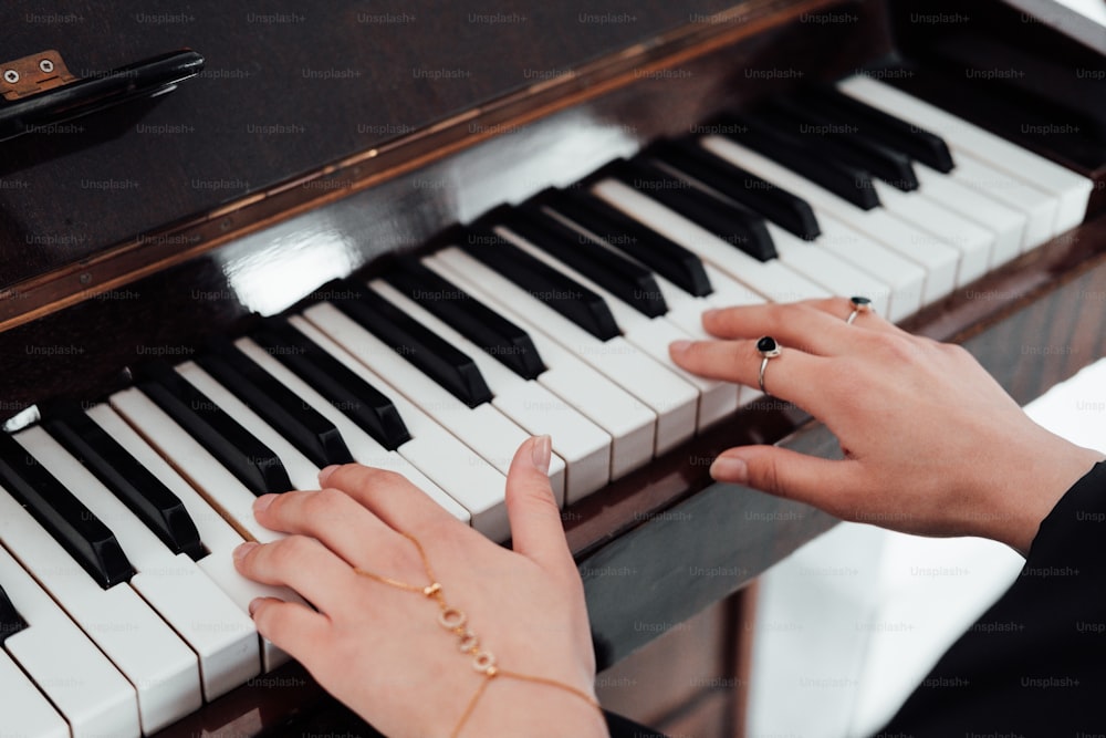 a woman is playing the piano with her hands
