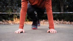 a man bending over on a skateboard on a sidewalk