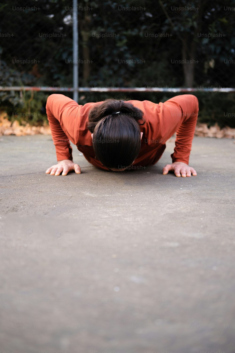 a woman is doing a handstand on a skateboard