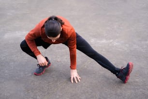 a woman in a red shirt and black leggings