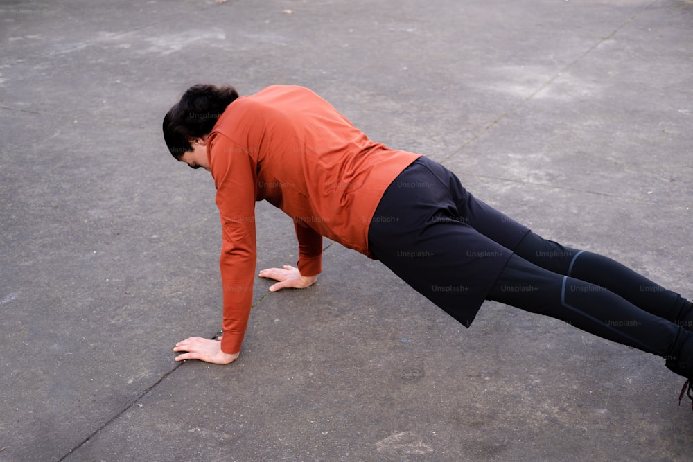 a woman is doing a push up on a skateboard