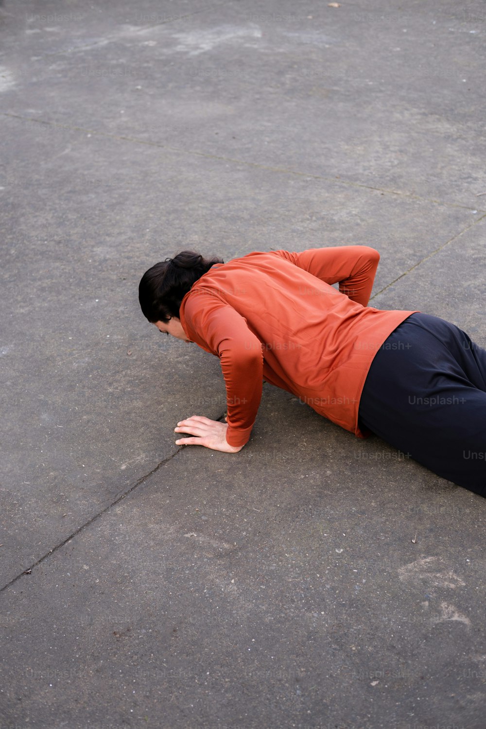 a man laying on the ground with his head down