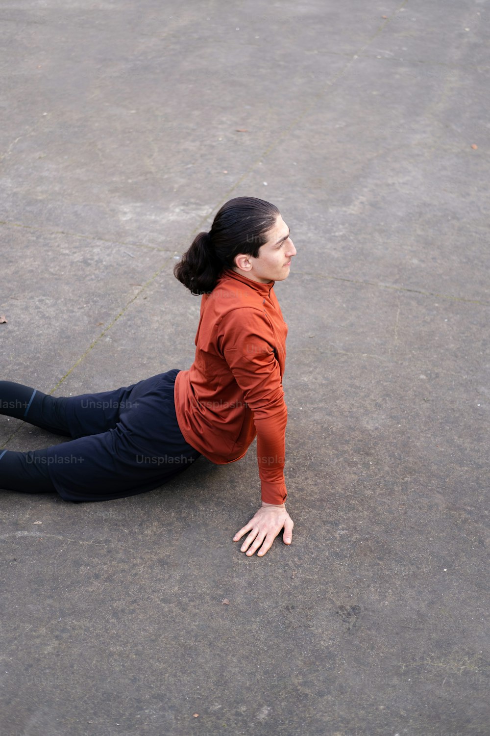 a woman laying on the ground in a parking lot