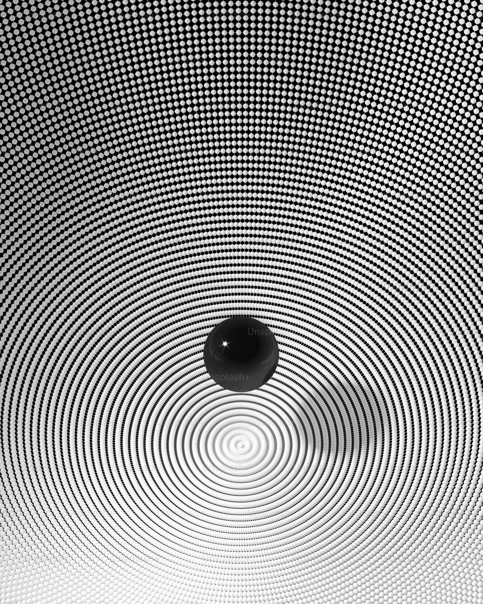 a black and white photo of a ball in the center of a black and white