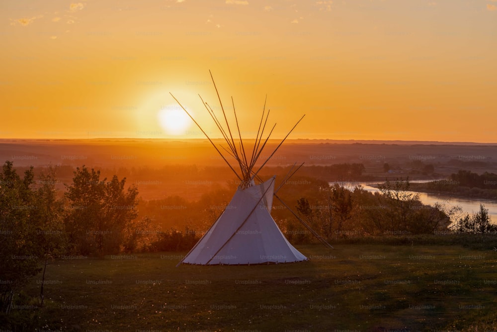 a teepee sitting on top of a lush green field