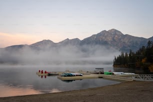 a body of water surrounded by mountains and a dock