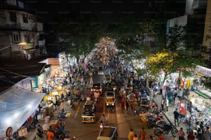 a crowded city street at night with lots of people