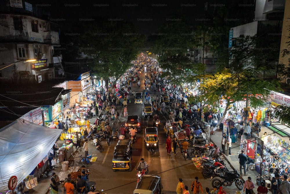 a crowded city street at night with lots of people