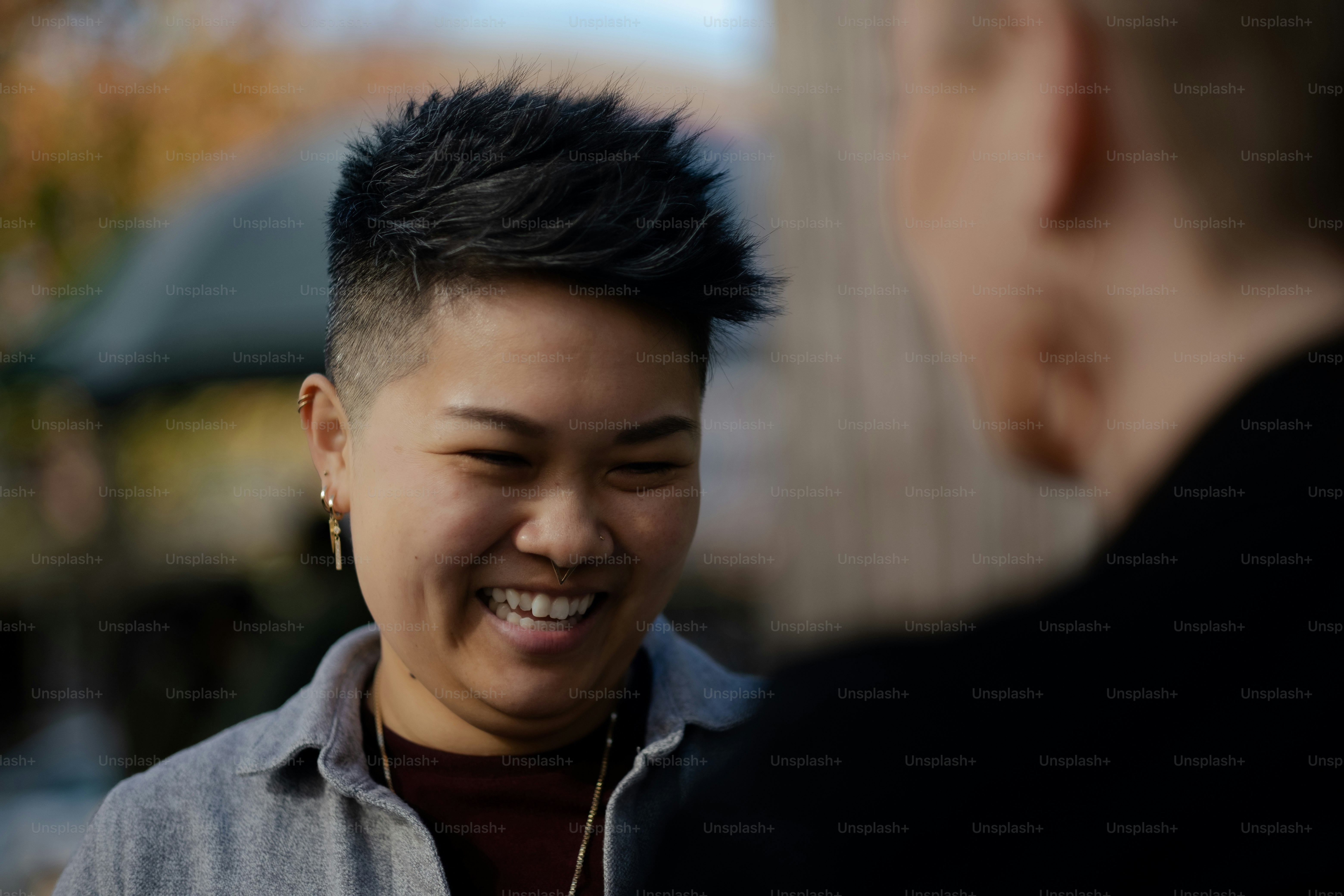 a woman smiling and talking to a man