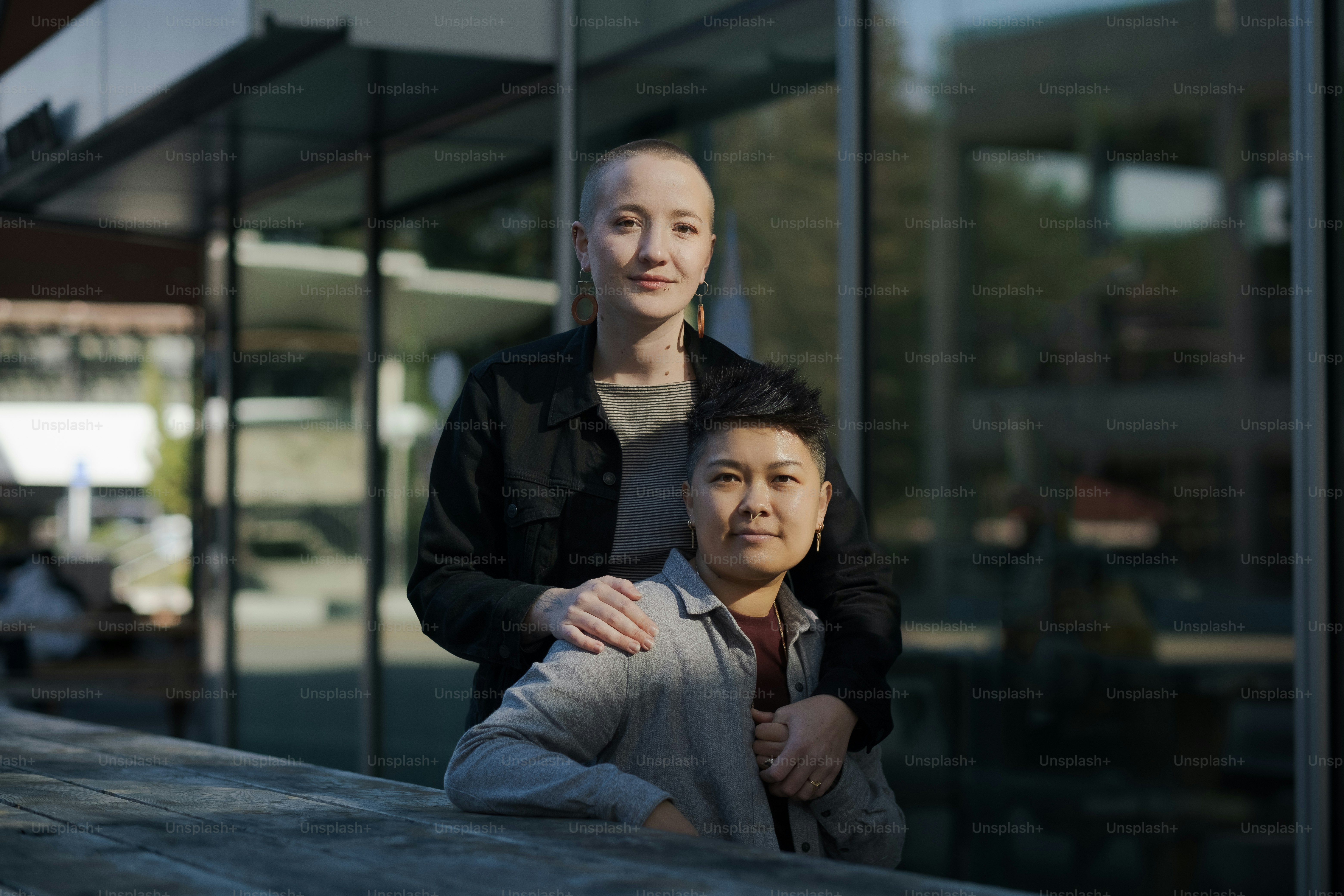 a woman standing next to a man in front of a building