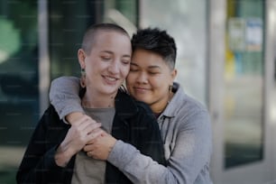 a woman hugging a man in front of a building