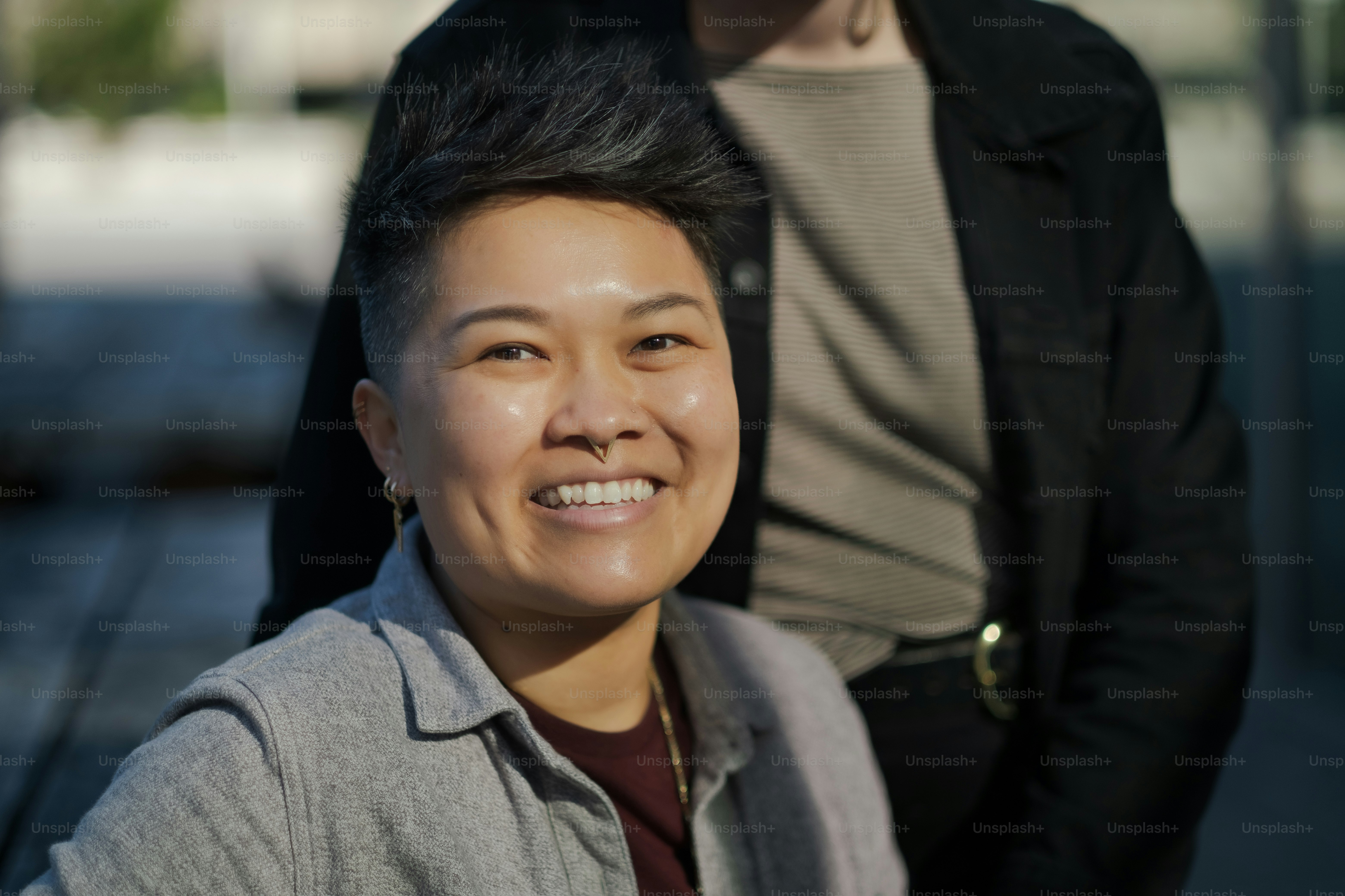 a woman is smiling while standing next to a man