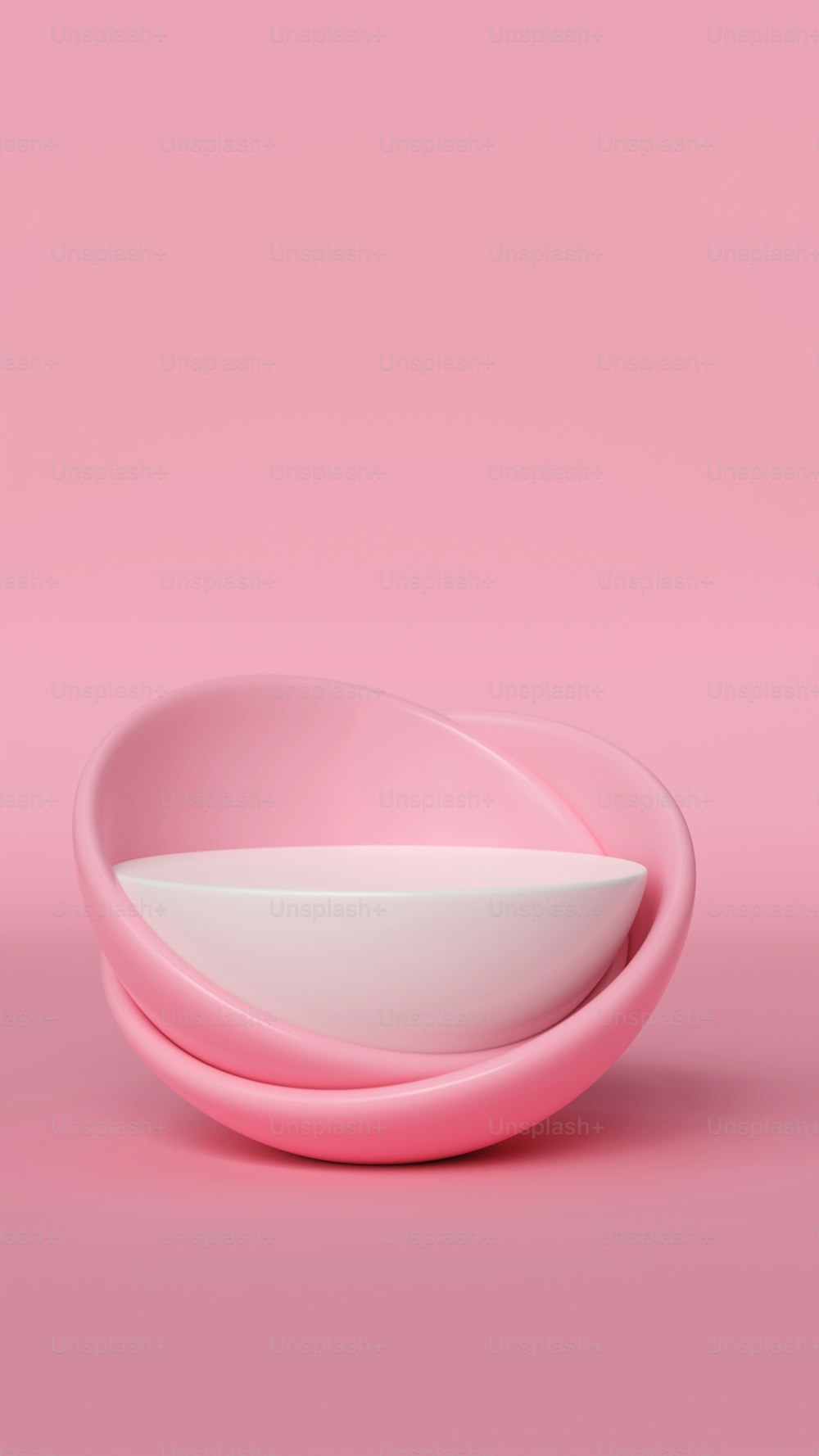 a pink and white bowl on a pink background