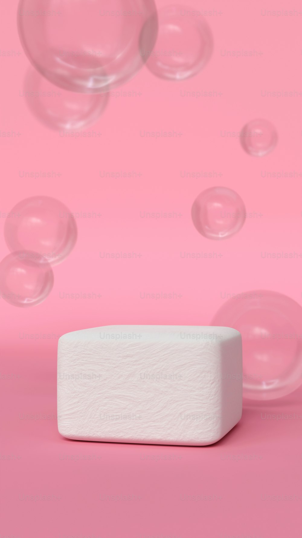 a soap bar sitting on top of a pink surface