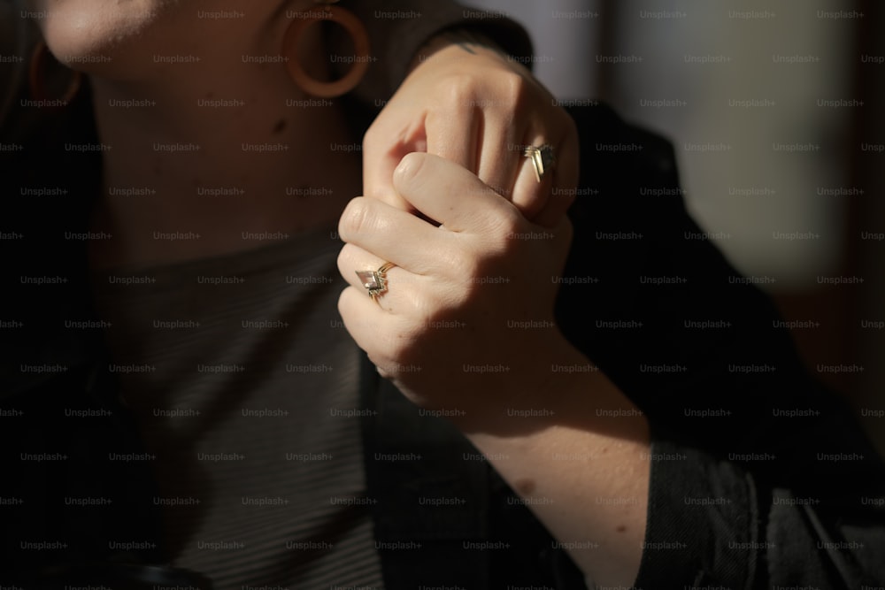 uma mulher vestindo um anel e uma camisa preta