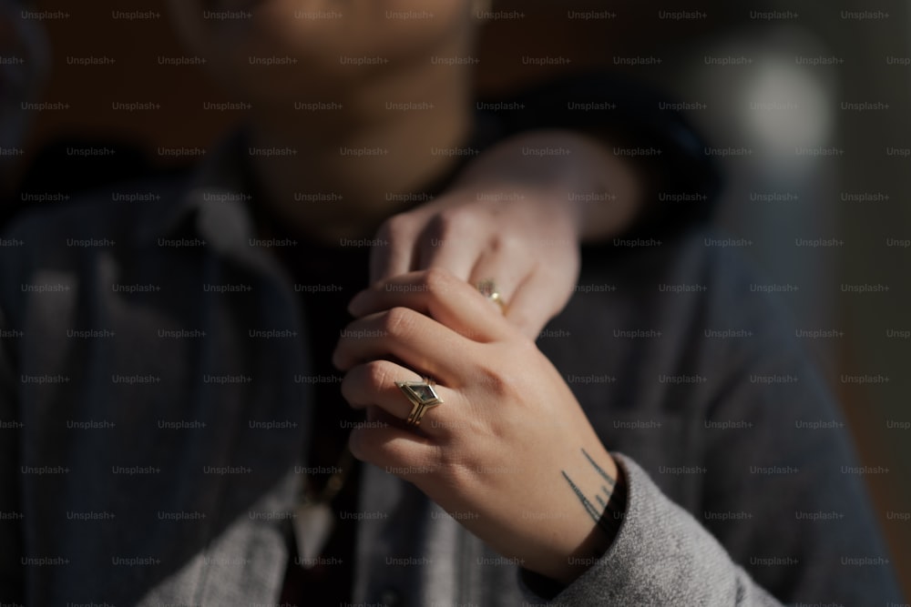 a person with a ring on their hand