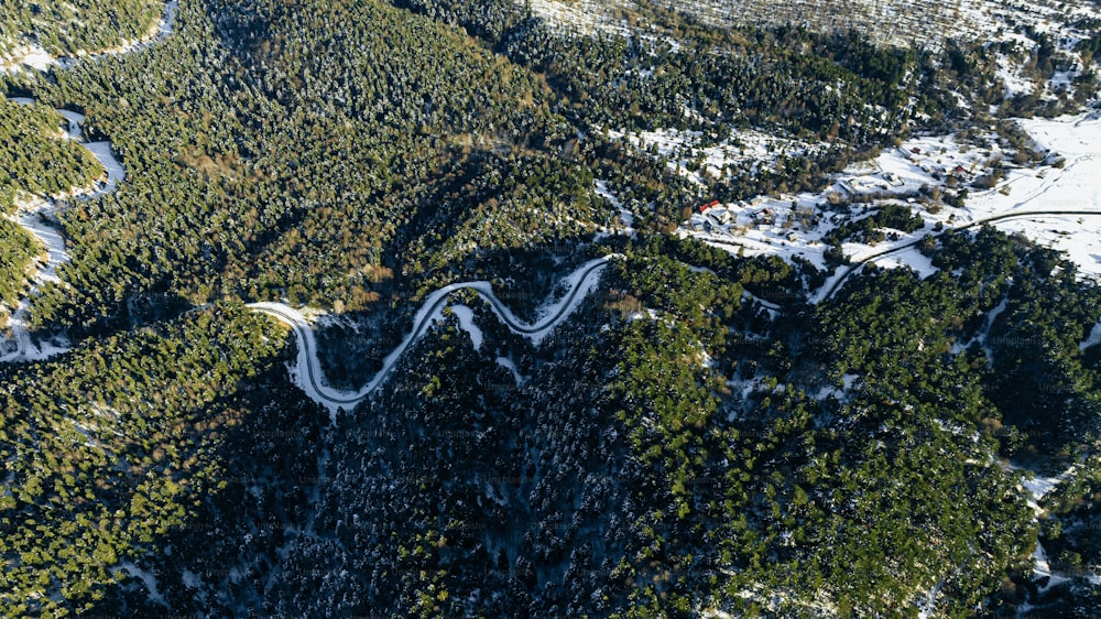 an aerial view of a winding road in the mountains