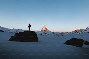 a man standing on top of a snow covered mountain