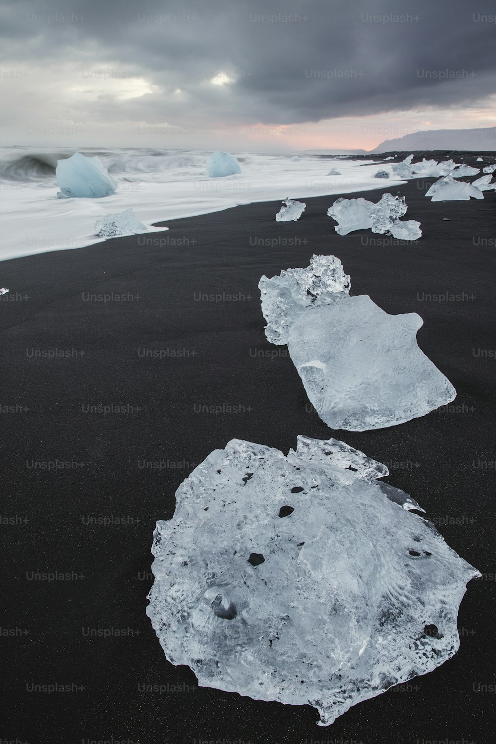 たくさんの氷に覆われた黒い砂浜