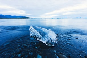 an iceberg floating on top of a body of water