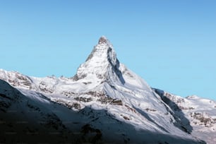 a snow covered mountain with a blue sky in the background