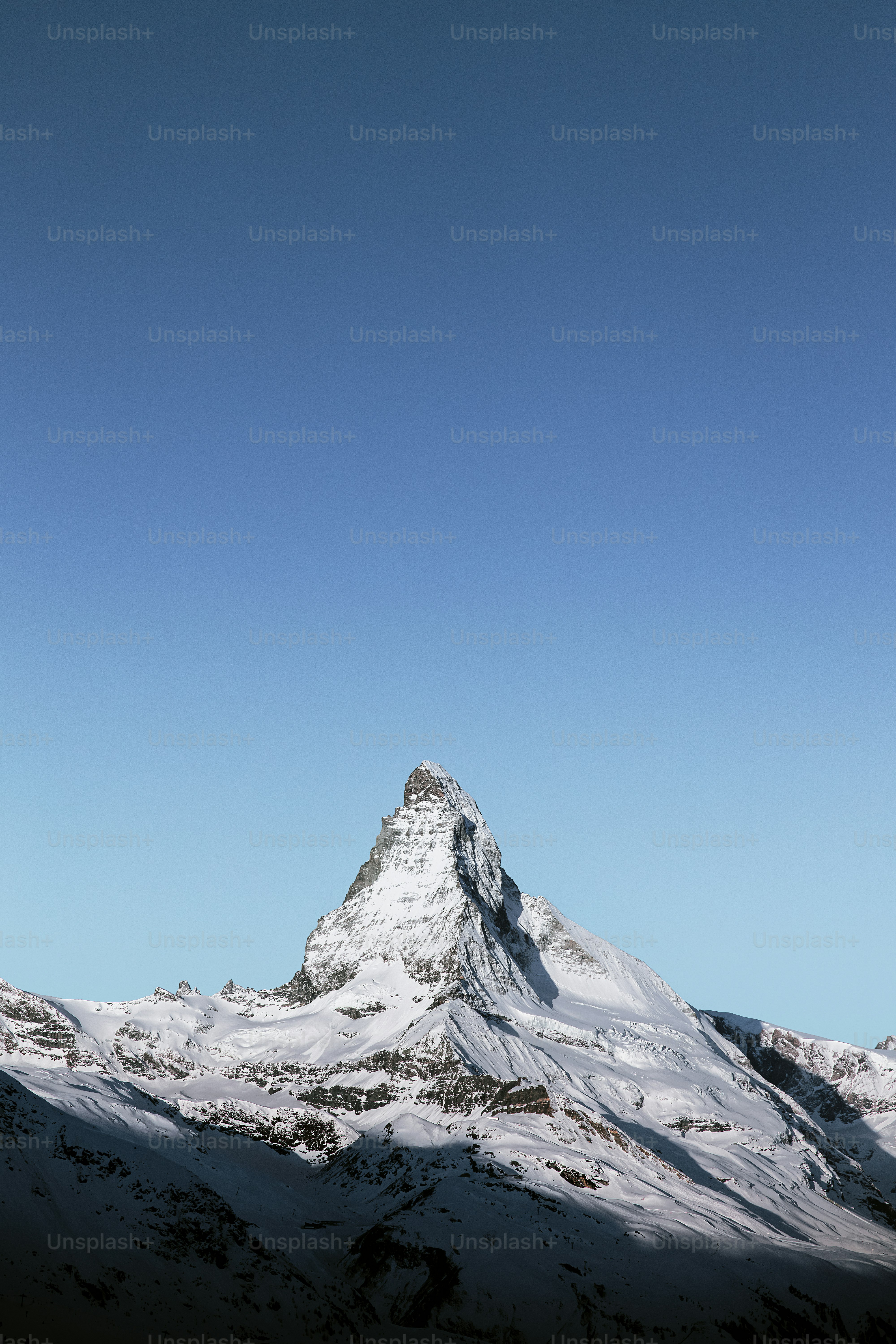 a snow covered mountain under a blue sky