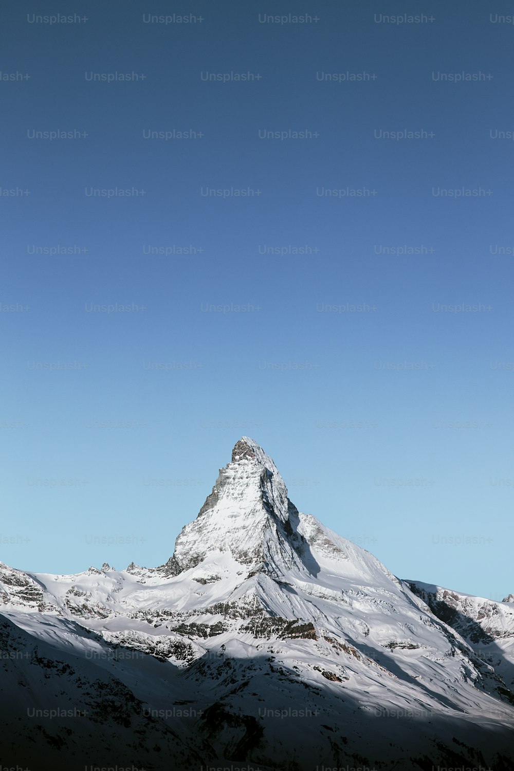 Ein schneebedeckter Berg unter blauem Himmel