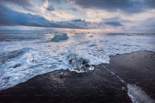 a large iceberg floating on top of a body of water