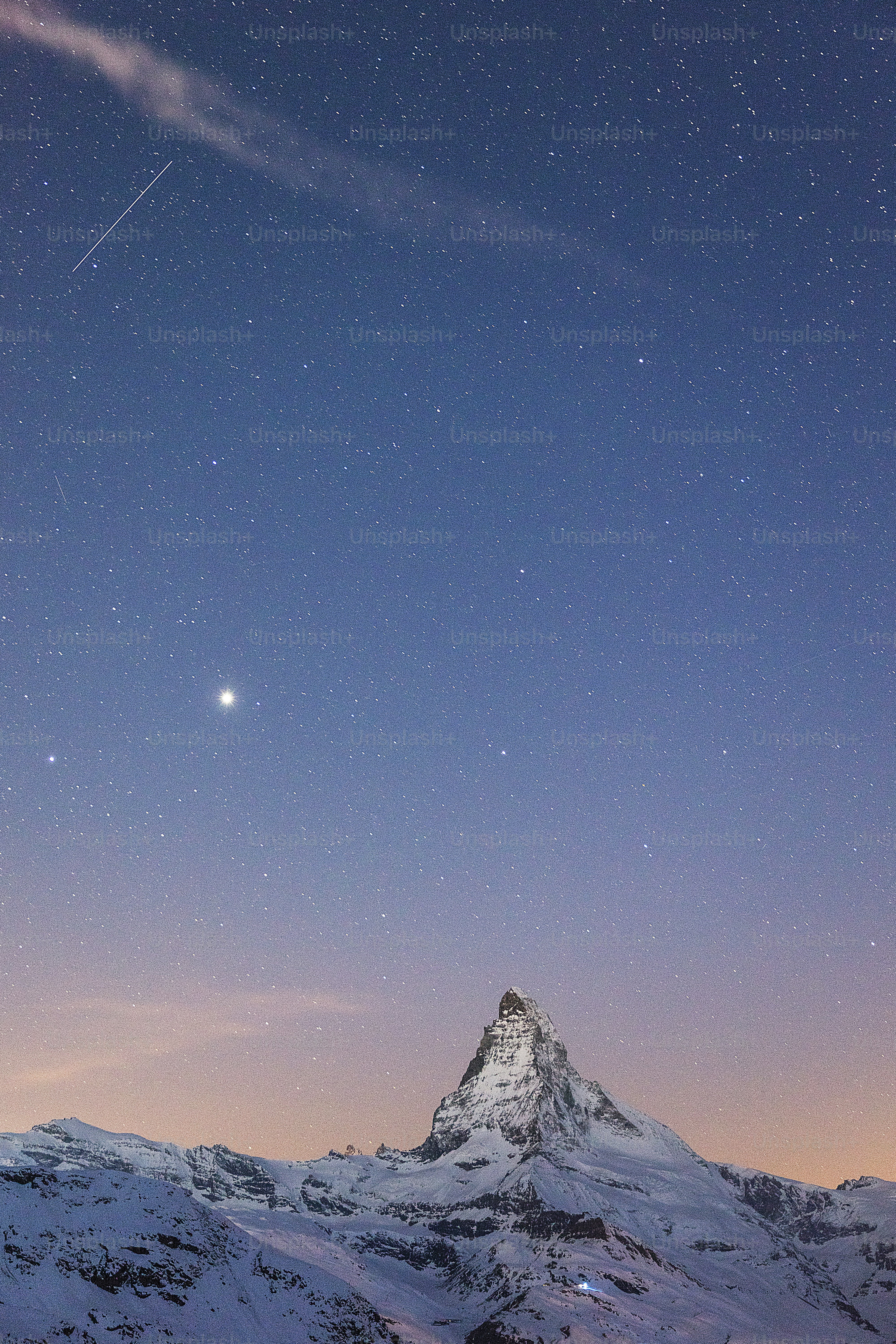 a mountain with a sky full of stars