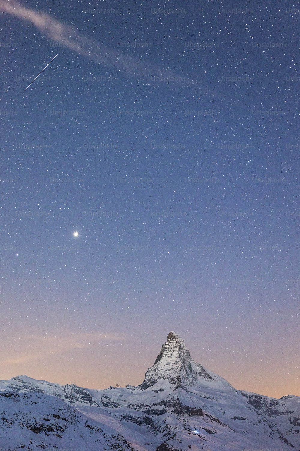 a mountain with a sky full of stars