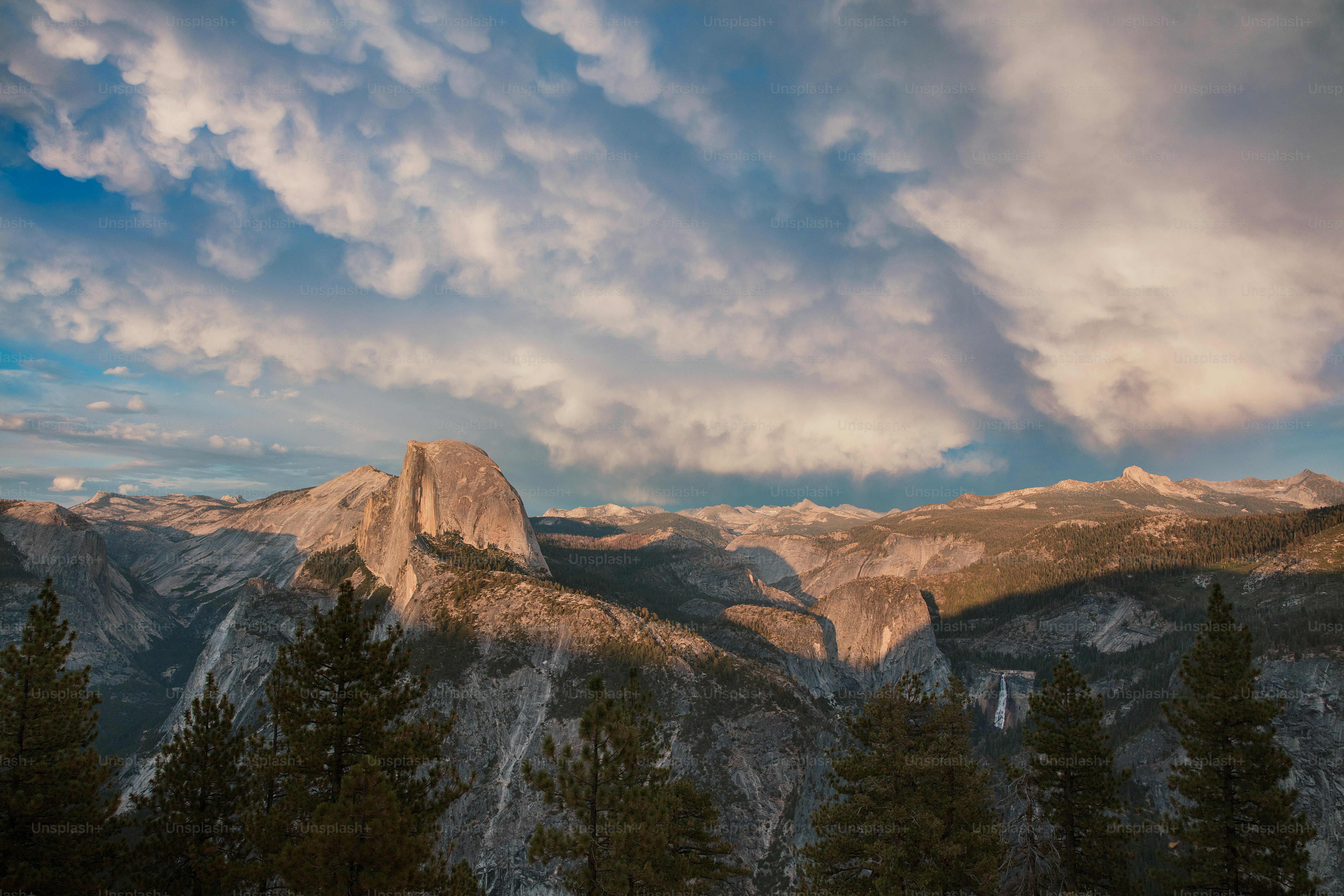 a view of a mountain range with clouds in the sky