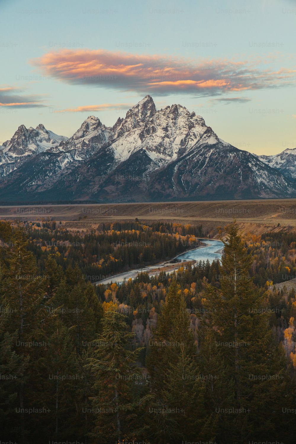 a mountain range with a river in the foreground