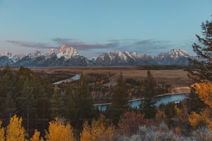 a scenic view of the grand tetons and the snake river