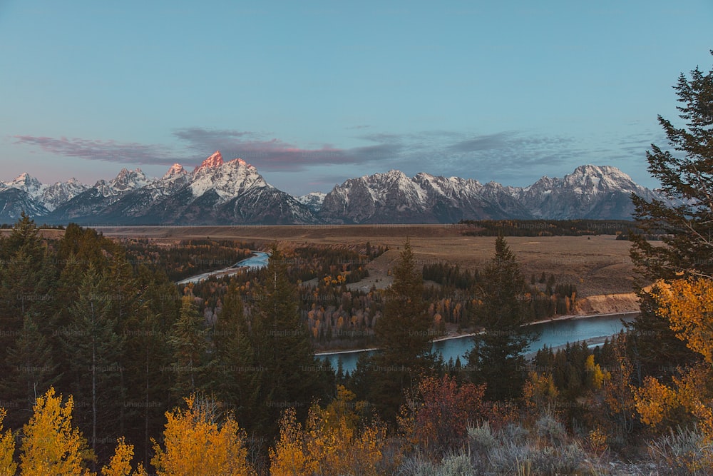 a scenic view of the grand tetons and the snake river