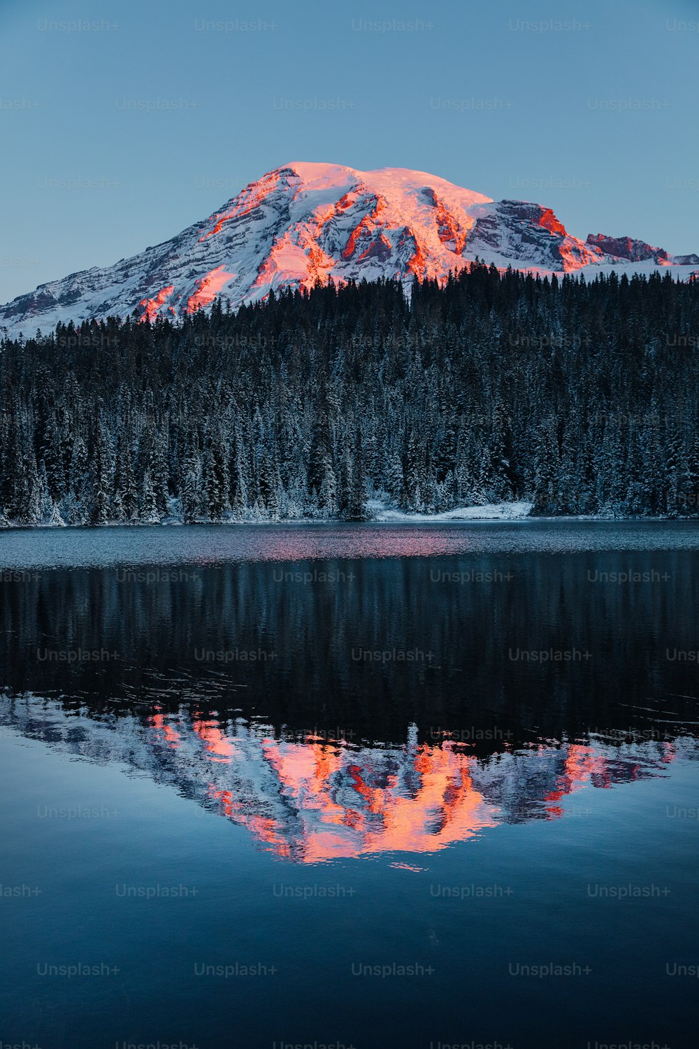 a mountain is shown with a lake in front of it