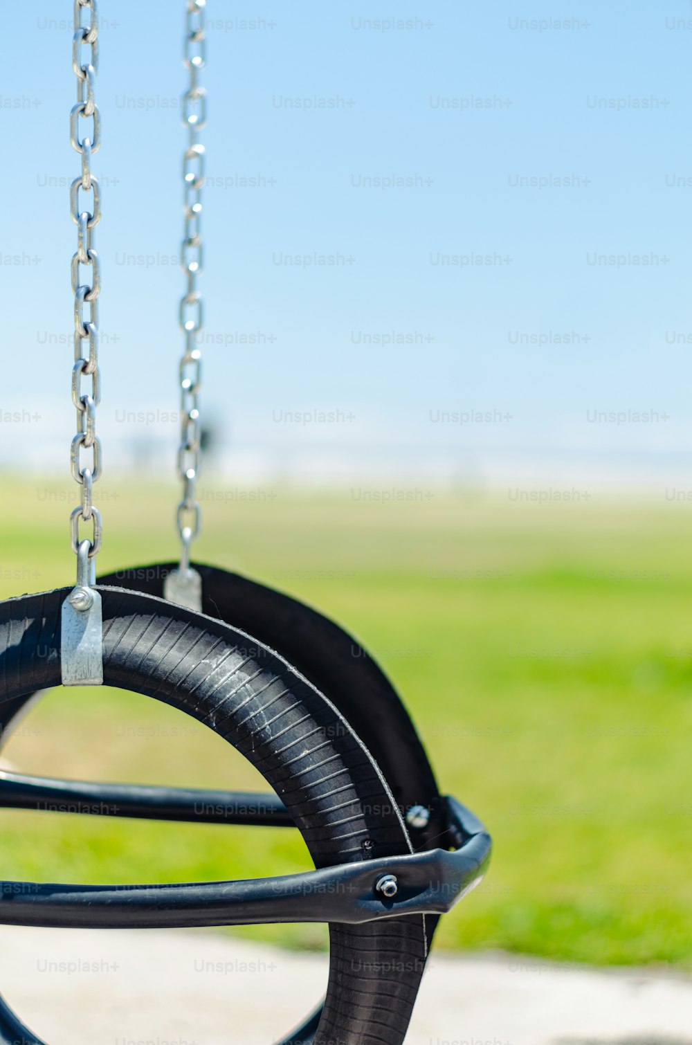 a close up of a tire swing in a park