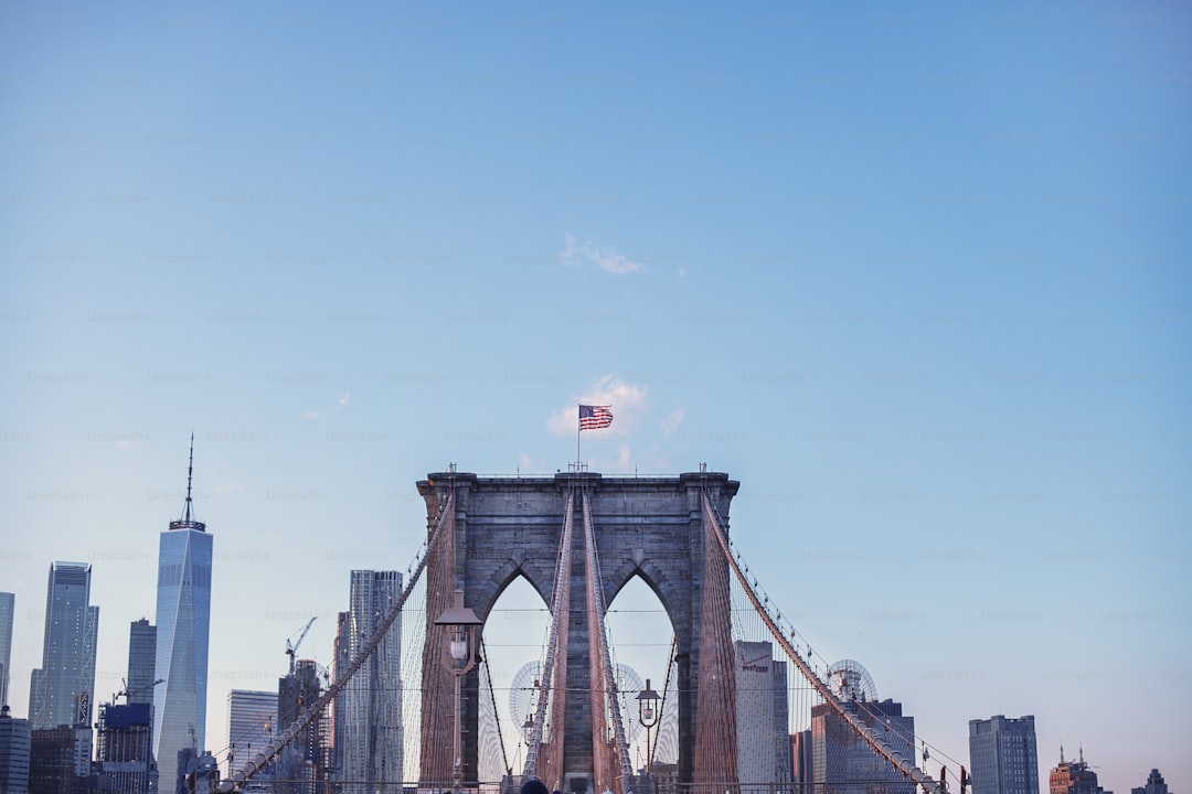 a tall bridge with a flag on top of it