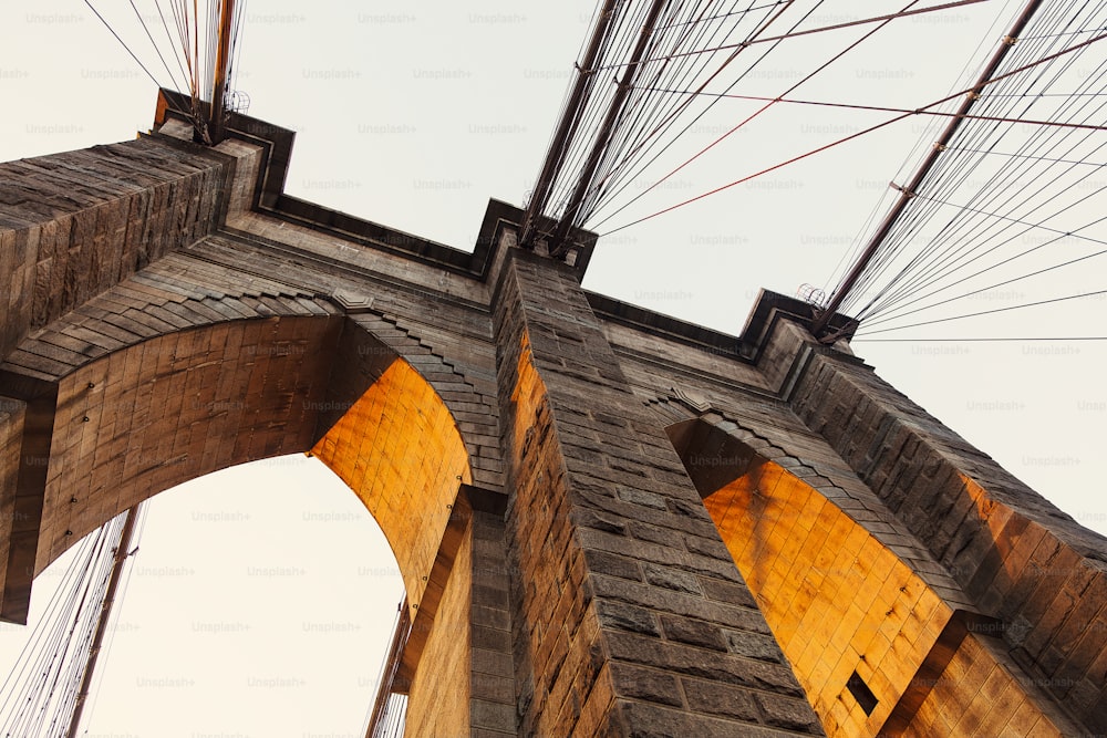 a very tall bridge with lots of wires above it