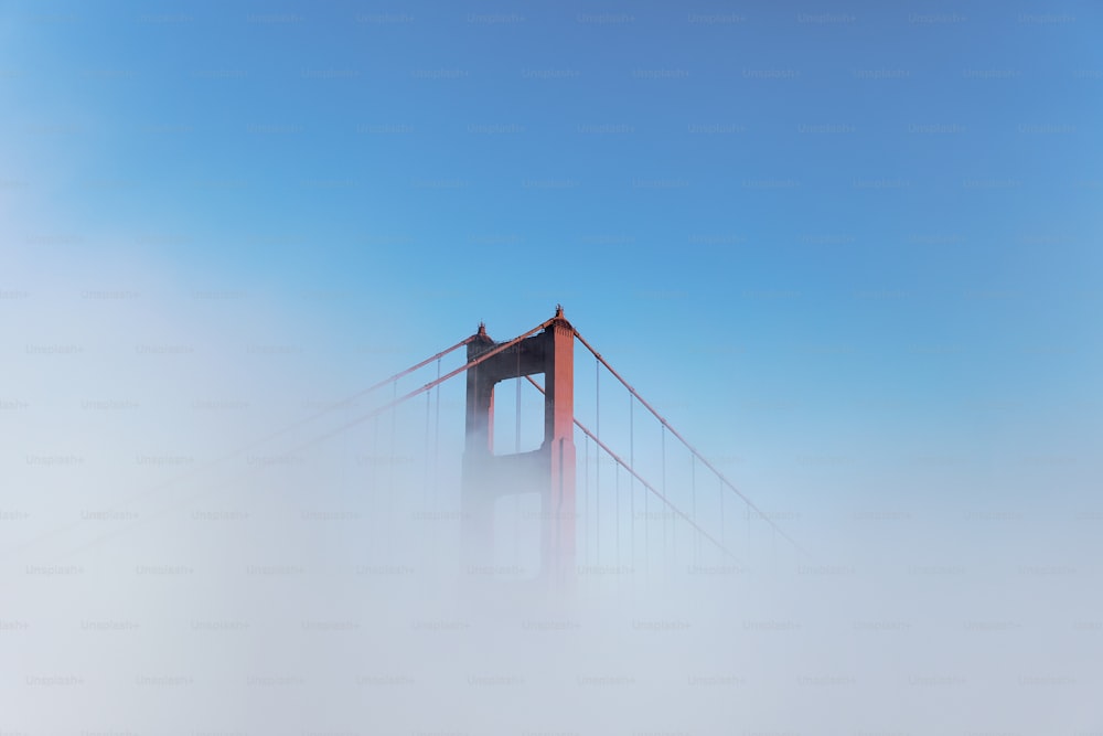 the golden gate bridge in the fog on a sunny day