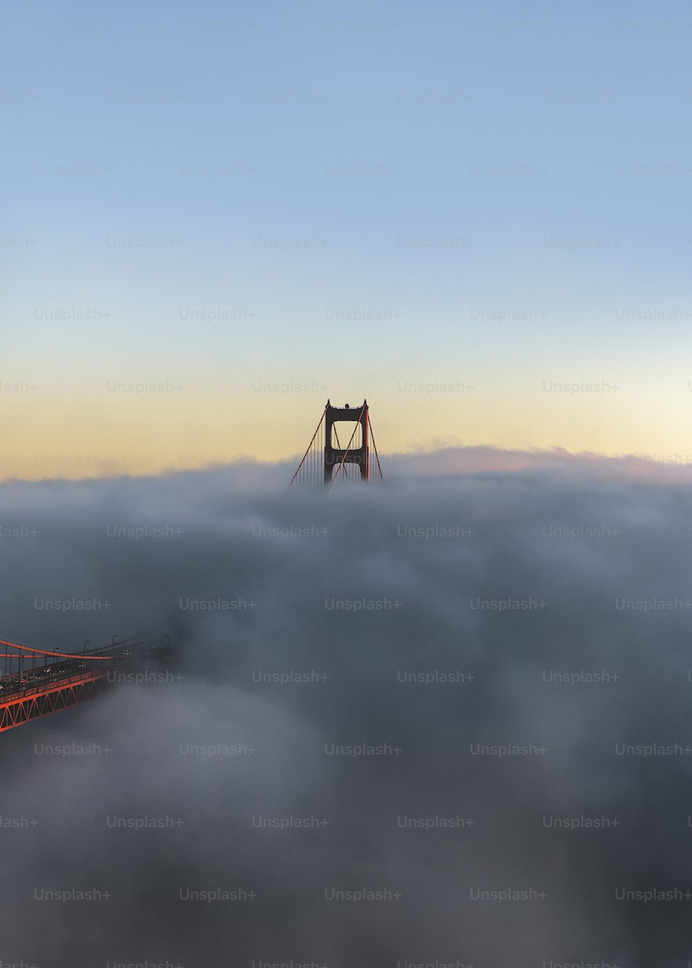 the golden gate bridge is surrounded by fog